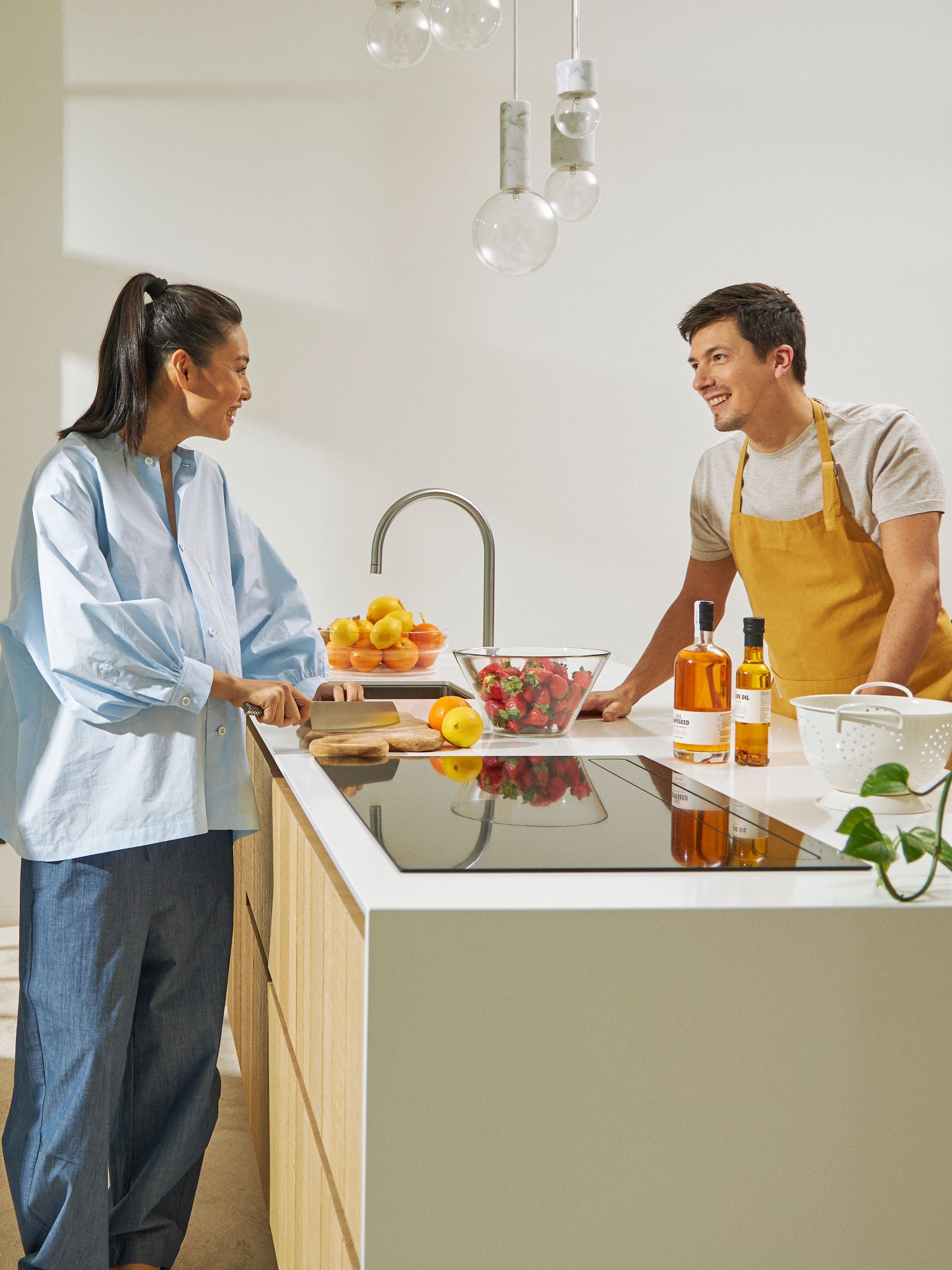 Par zajedno kuha jelo u kuhinji